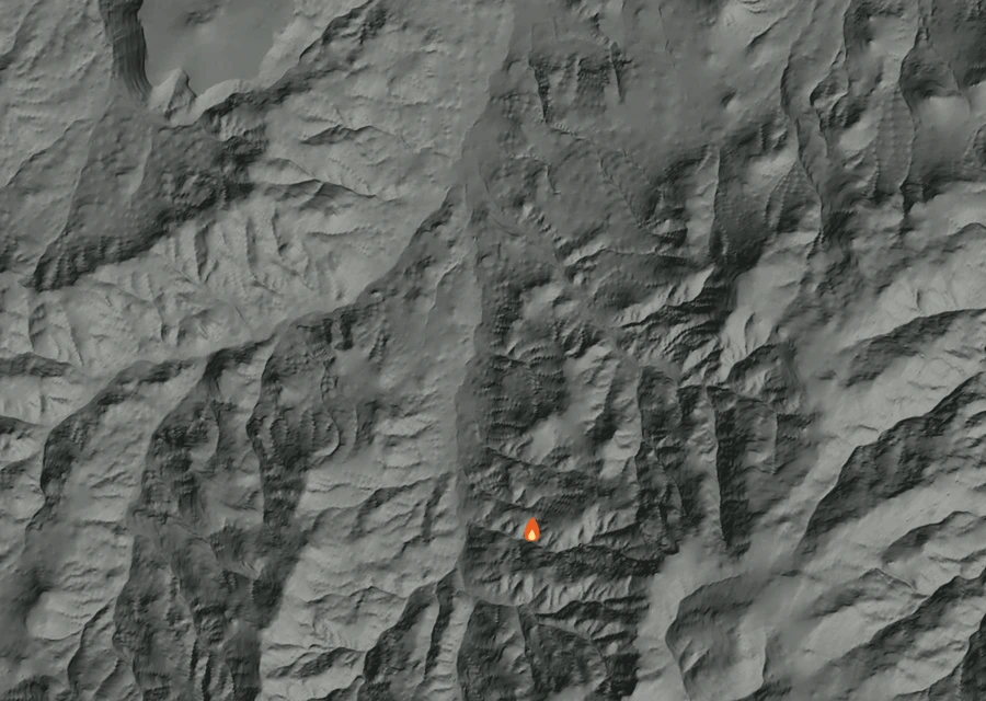 Shaded relief map of the 0500 Coyote Fire. Amber flames mark every place that gave off heat in the last day; the shading is the shape of the ground.