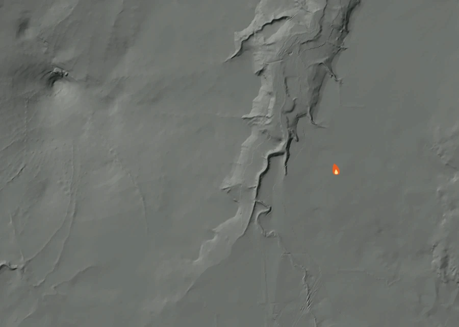Shaded relief map of the 0658 Round Butte Fire. Amber flames mark every place that gave off heat in the last day; the shading is the shape of the ground.