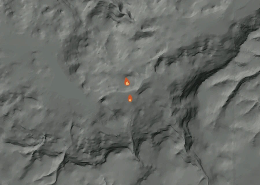Shaded relief map of the 0903 Gray Creek Fire. Amber flames mark every place that gave off heat in the last day; the shading is the shape of the ground.