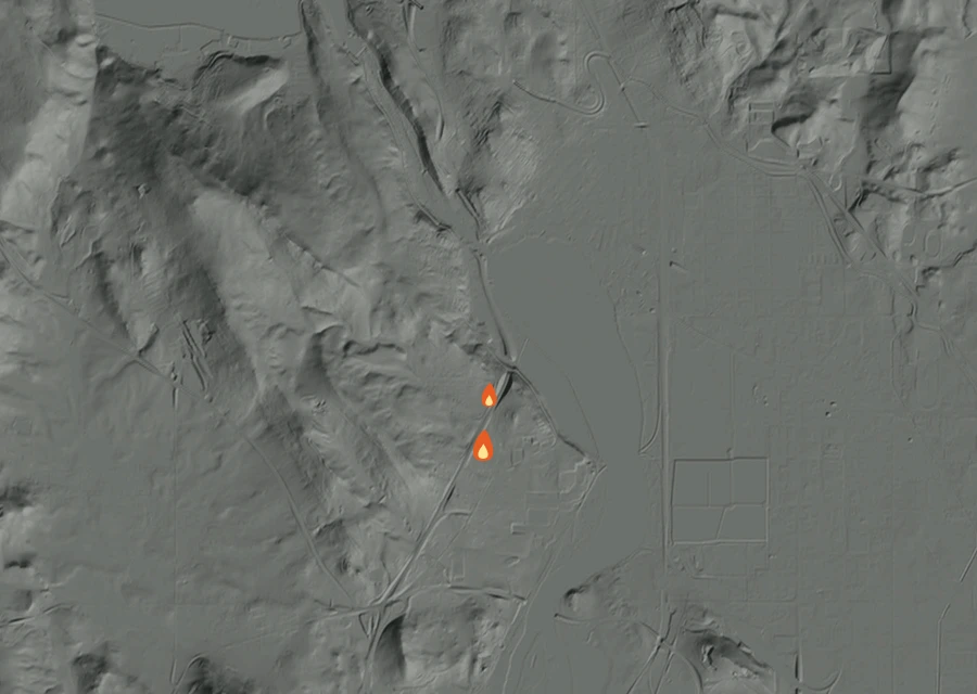 Shaded relief map of the 397 Fire. Amber flames mark every place that gave off heat in the last day; the shading is the shape of the ground.