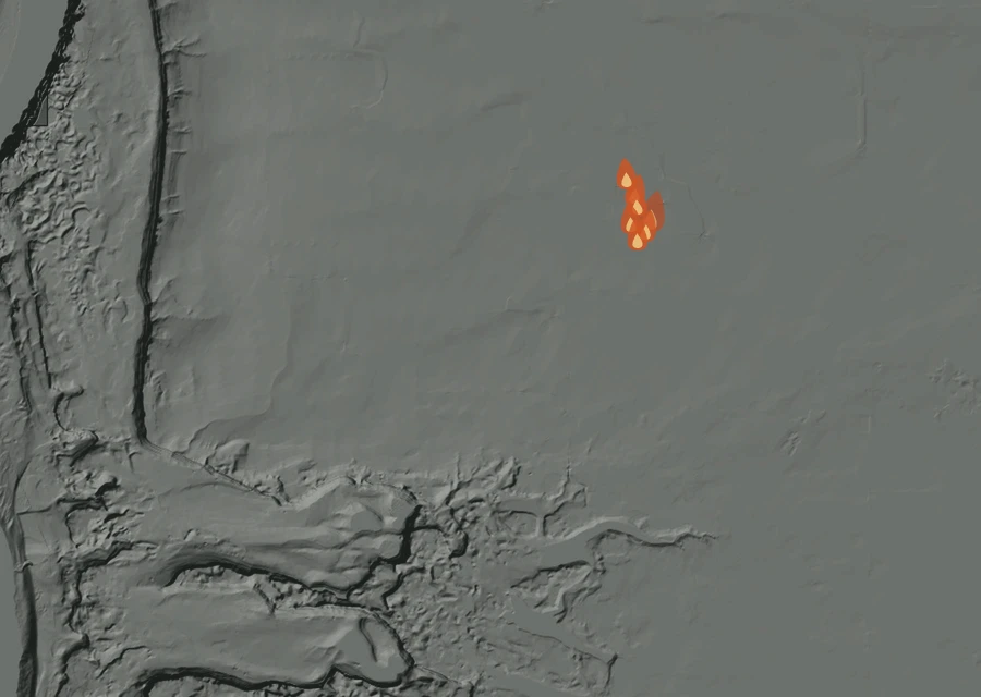 Shaded relief map of the Ancient Lakes Fire. Amber flames mark every place that gave off heat in the last day; the shading is the shape of the ground.