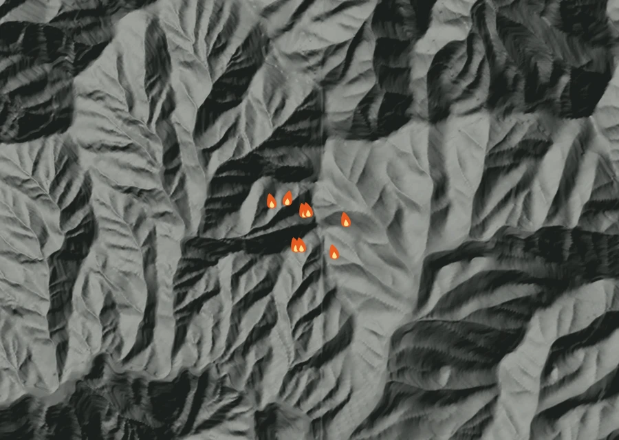 Shaded relief map of the Anderson Butte Rd MM4 Fire. Amber flames mark every place that gave off heat in the last day; the shading is the shape of the ground.