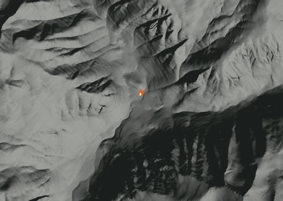 Shaded relief map of the Arrow Creek Fire. Amber flames mark every place that gave off heat in the last day; the shading is the shape of the ground.