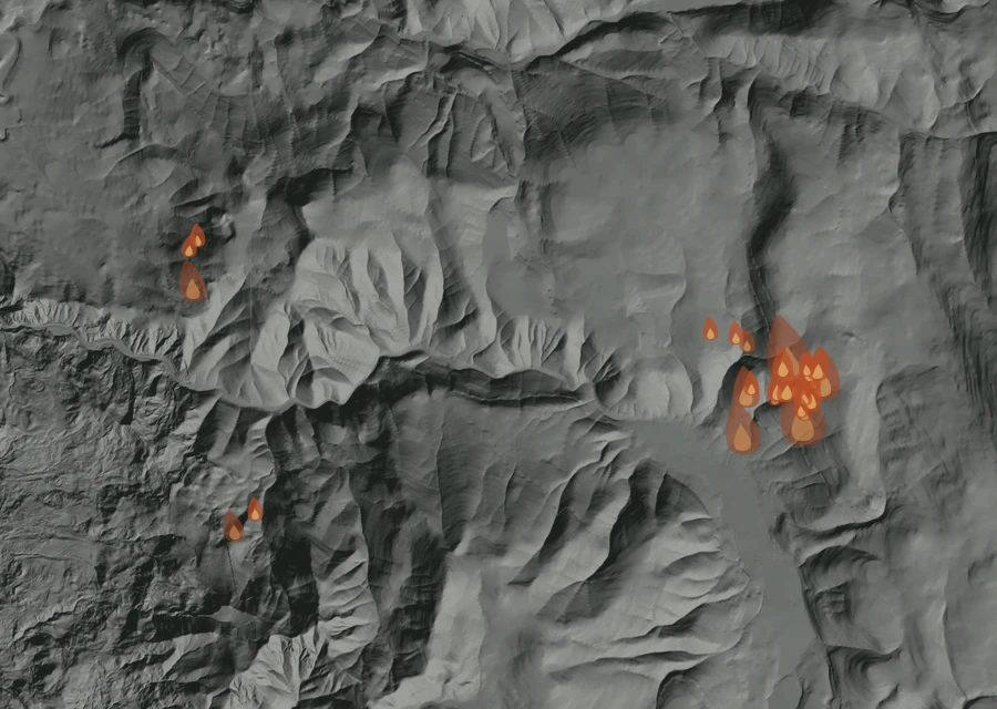 Shaded relief map of the Austin Fire. Amber flames mark every place that gave off heat in the last day; the shading is the shape of the ground.