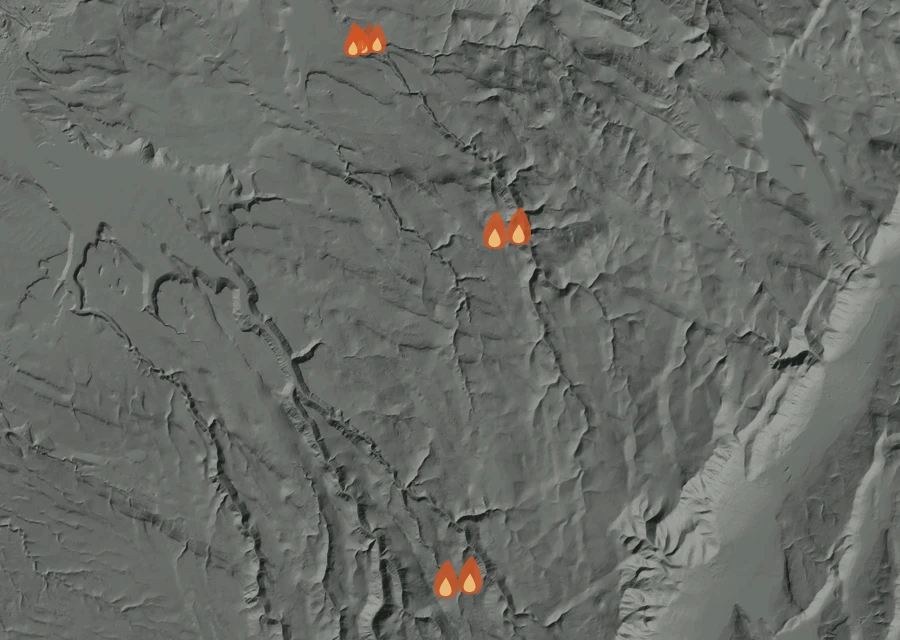 Shaded relief map of the Bald Mountain Fire. Amber flames mark every place that gave off heat in the last day; the shading is the shape of the ground.