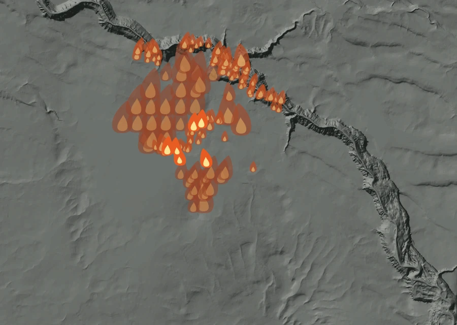 Shaded relief map of the Big Grass Fire. Amber flames mark every place that gave off heat in the last day; the shading is the shape of the ground.