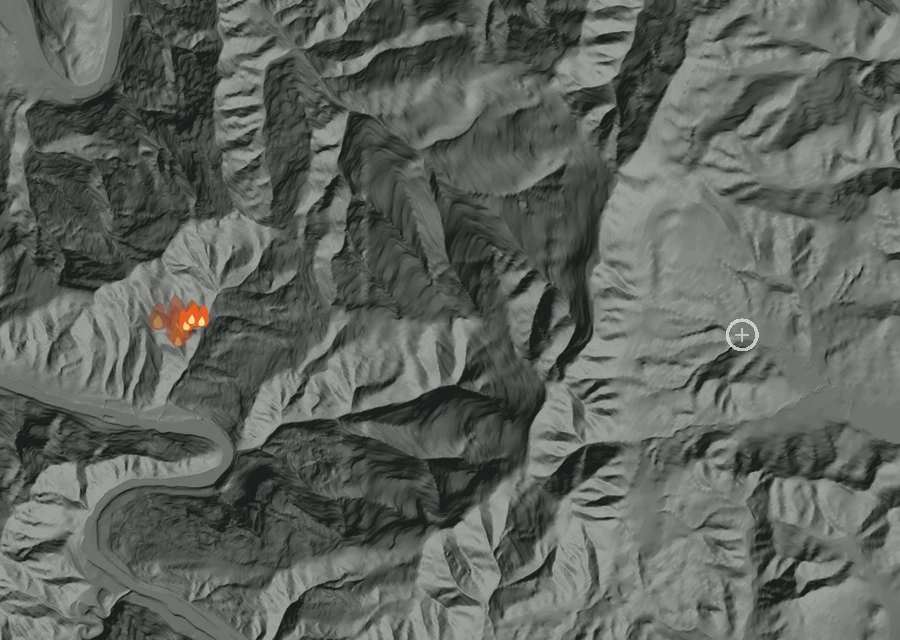 Shaded relief map of the Bottle Creek Fire. Amber flames mark every place that gave off heat in the last day; the shading is the shape of the ground.