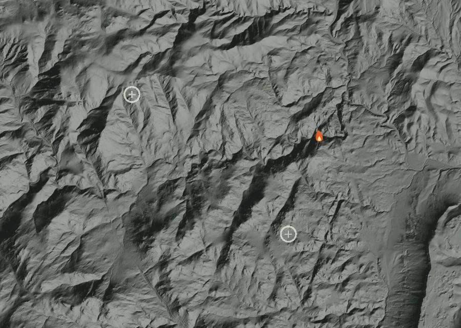 Shaded relief map of the Burnett Gulch Fire. Amber flames mark every place that gave off heat in the last day; the shading is the shape of the ground.