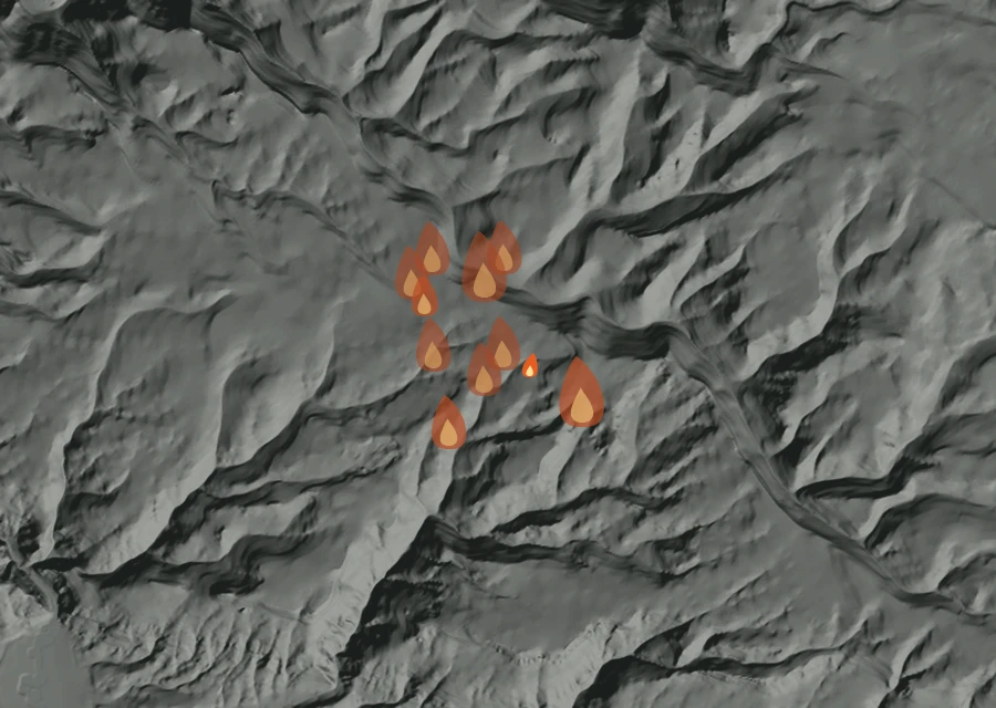 Shaded relief map of the Cabin Springs Fire. Amber flames mark every place that gave off heat in the last day; the shading is the shape of the ground.