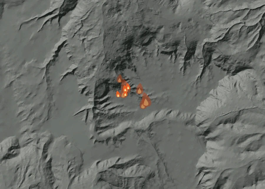 Shaded relief map of the Chalk Mountain Fire. Amber flames mark every place that gave off heat in the last day; the shading is the shape of the ground.