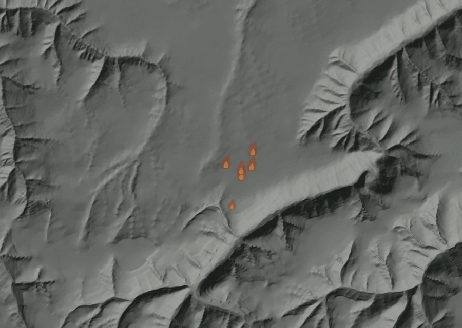Shaded relief map of the Columbia Center Mutual Aid Fire. Amber flames mark every place that gave off heat in the last day; the shading is the shape of the ground.