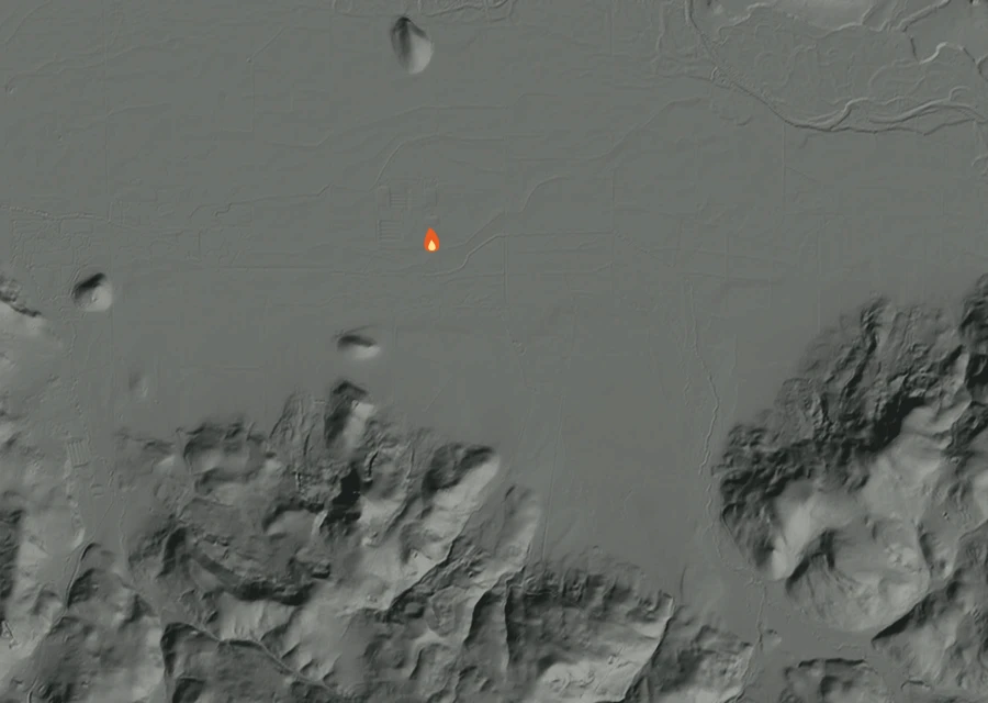 Shaded relief map of the Courtney Creek 100 Fire. Amber flames mark every place that gave off heat in the last day; the shading is the shape of the ground.