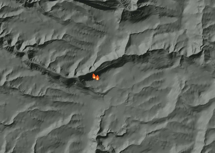 Shaded relief map of the Cow Camp Fire. Amber flames mark every place that gave off heat in the last day; the shading is the shape of the ground.