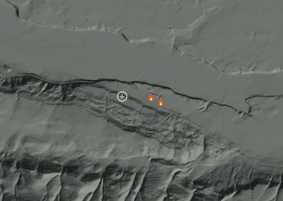 Shaded relief map of the Crab Fire. Amber flames mark every place that gave off heat in the last day; the shading is the shape of the ground.