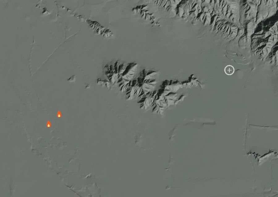Shaded relief map of the Darby Fire. Amber flames mark every place that gave off heat in the last day; the shading is the shape of the ground.