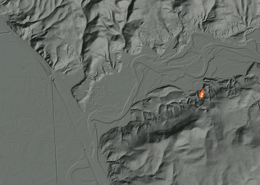 Shaded relief map of the Dike Fire. Amber flames mark every place that gave off heat in the last day; the shading is the shape of the ground.