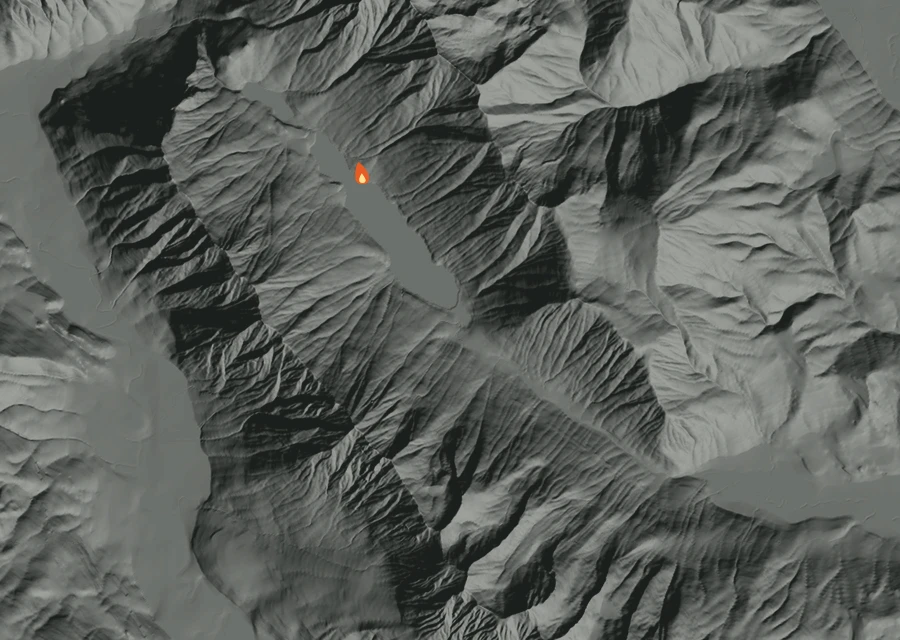 Shaded relief map of the Dirtyface Fire. Amber flames mark every place that gave off heat in the last day; the shading is the shape of the ground.