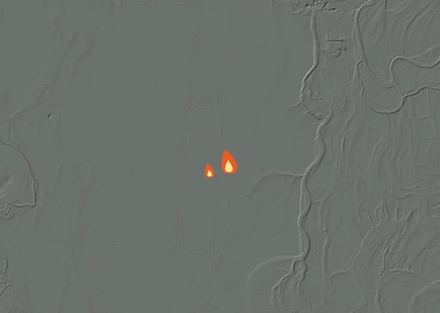 Shaded relief map of the East 99 Non-Stat Fire. Amber flames mark every place that gave off heat in the last day; the shading is the shape of the ground.