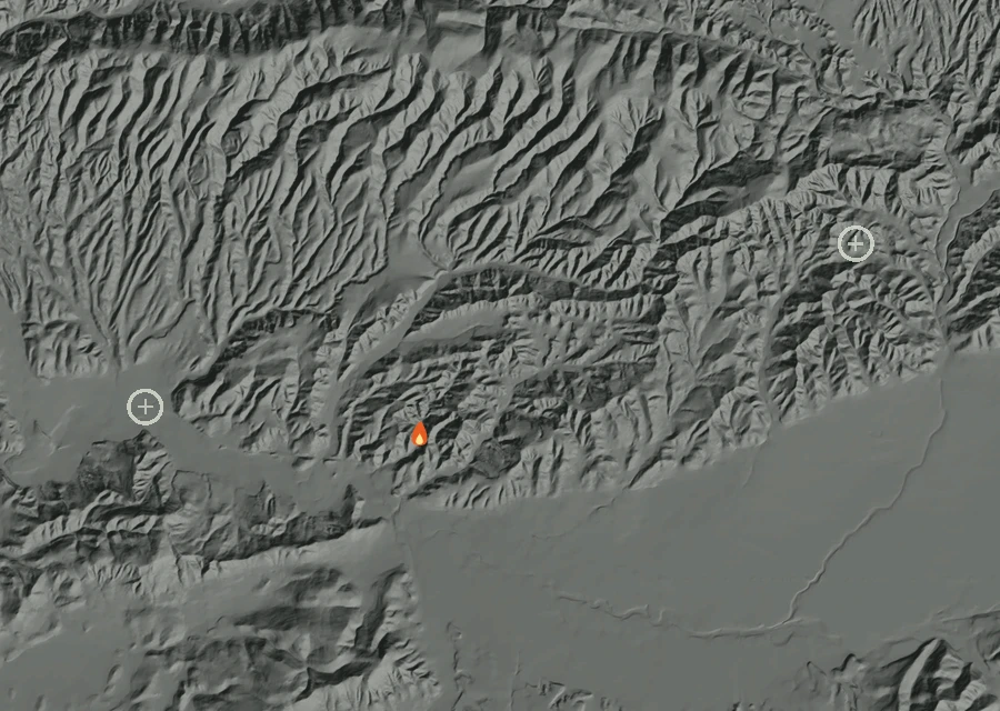 Shaded relief map of the Easy Fire. Amber flames mark every place that gave off heat in the last day; the shading is the shape of the ground.