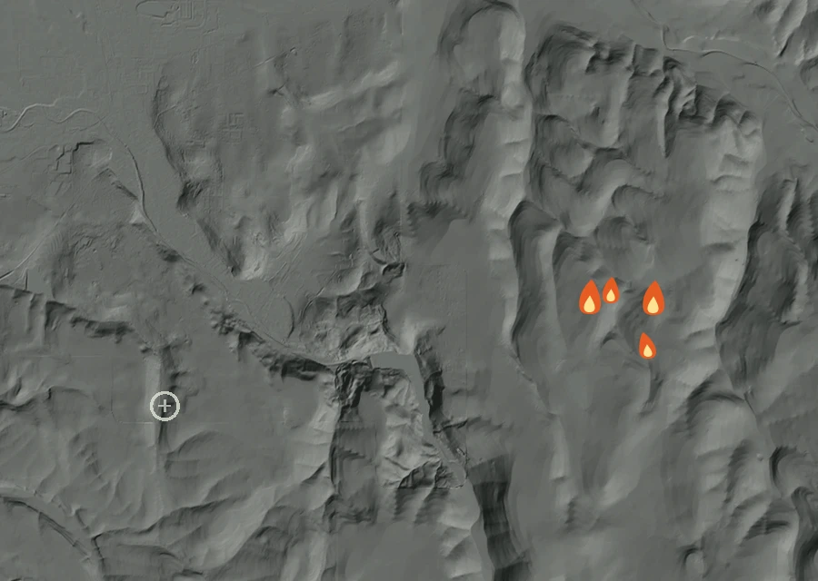 Shaded relief map of the Evans Creek 31 Fire. Amber flames mark every place that gave off heat in the last day; the shading is the shape of the ground.