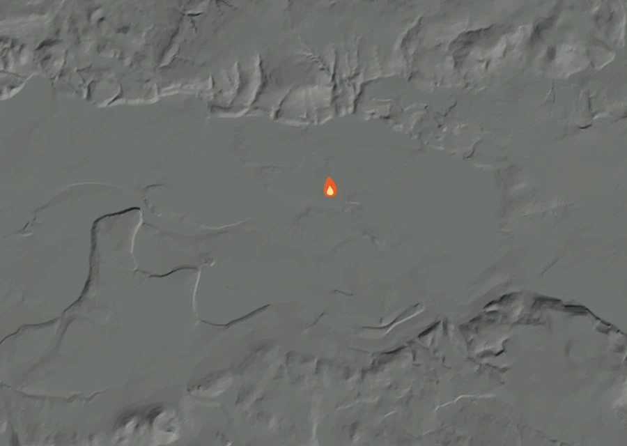 Shaded relief map of the Falls Fire. Amber flames mark every place that gave off heat in the last day; the shading is the shape of the ground.