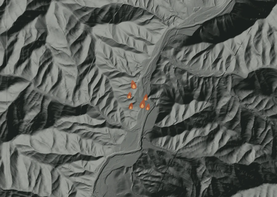 Shaded relief map of the Flumet Fire. Amber flames mark every place that gave off heat in the last day; the shading is the shape of the ground.