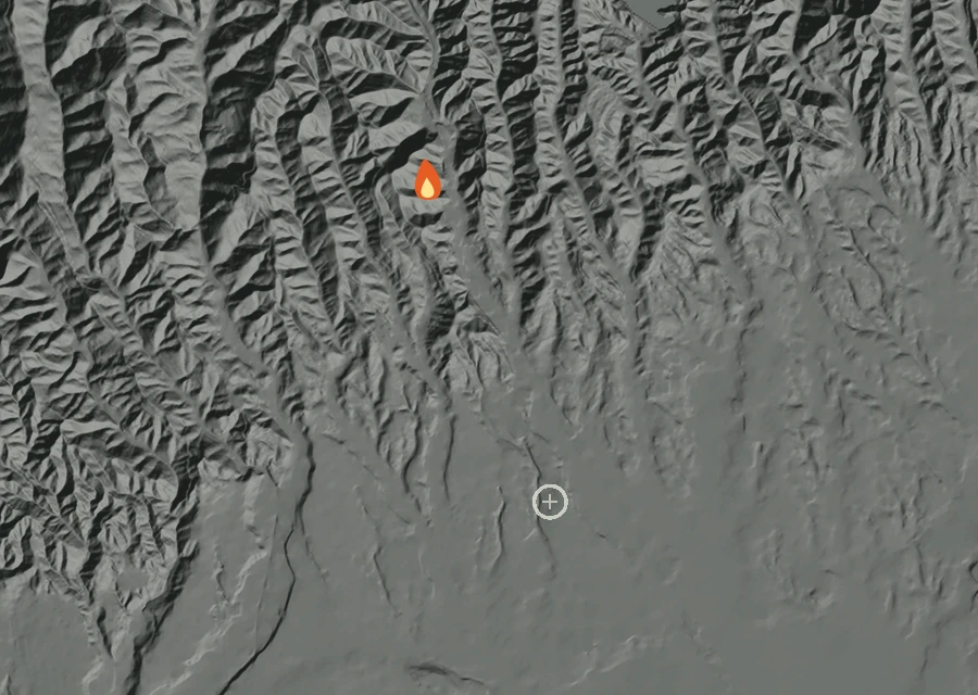 Shaded relief map of the Getty Fire. Amber flames mark every place that gave off heat in the last day; the shading is the shape of the ground.
