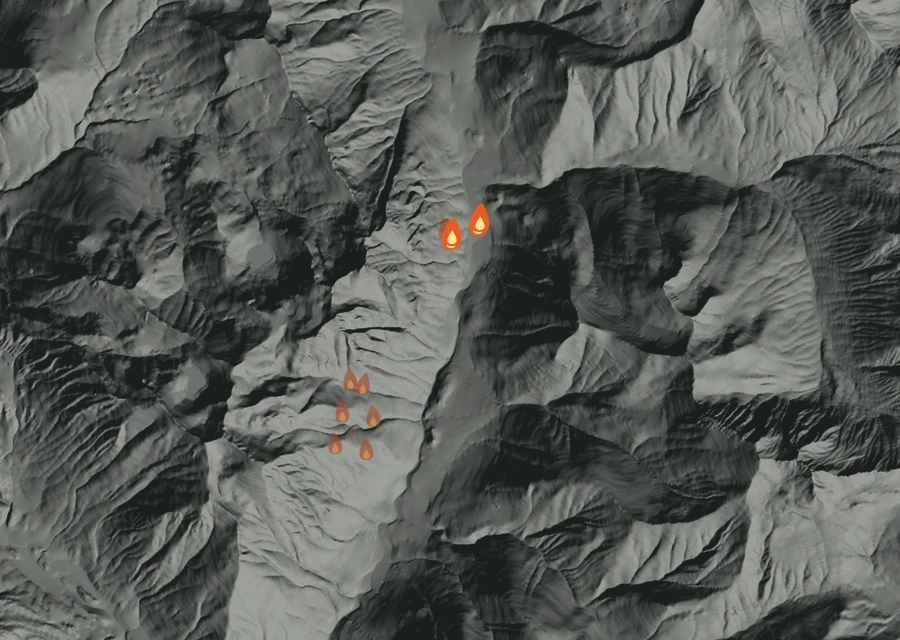 Shaded relief map of the Goat Fire. Amber flames mark every place that gave off heat in the last day; the shading is the shape of the ground.
