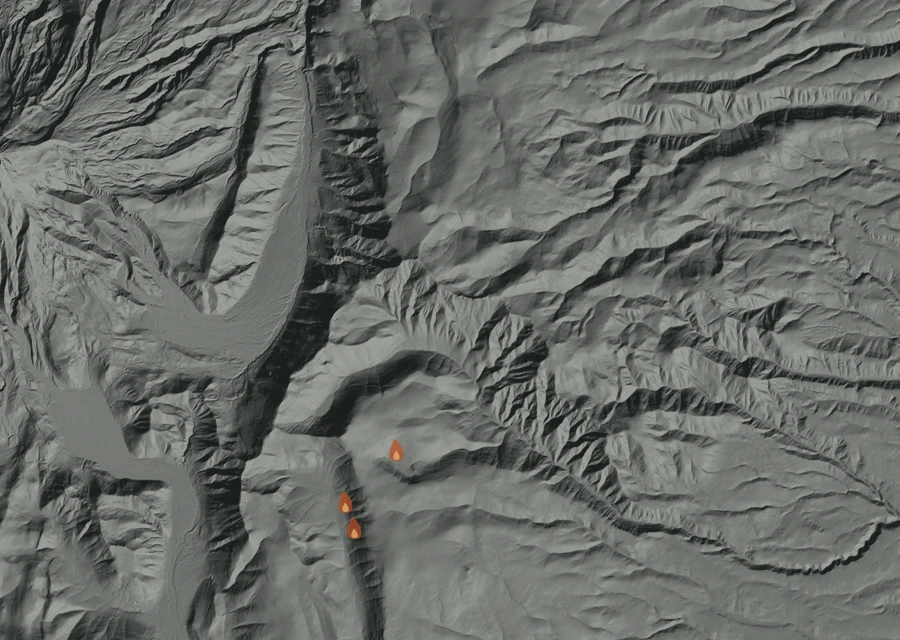 Shaded relief map of the Grasshopper Fire. Amber flames mark every place that gave off heat in the last day; the shading is the shape of the ground.