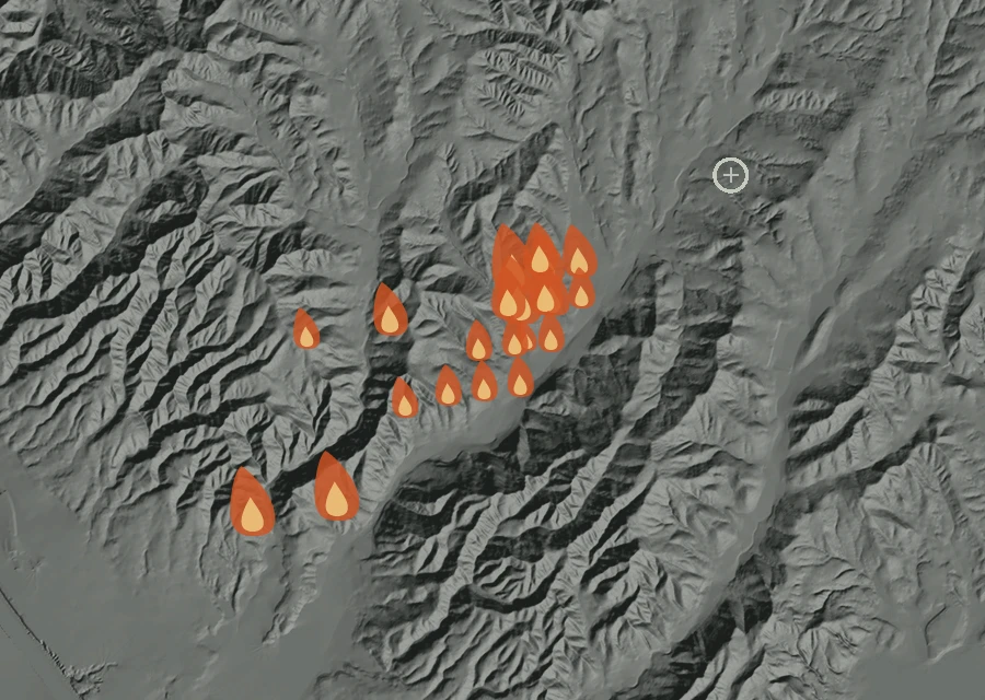 Shaded relief map of the Henderson Fire. Amber flames mark every place that gave off heat in the last day; the shading is the shape of the ground.