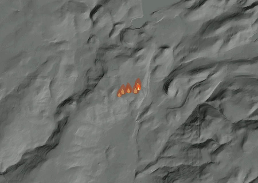 Shaded relief map of the Hidden Meadow Fire. Amber flames mark every place that gave off heat in the last day; the shading is the shape of the ground.
