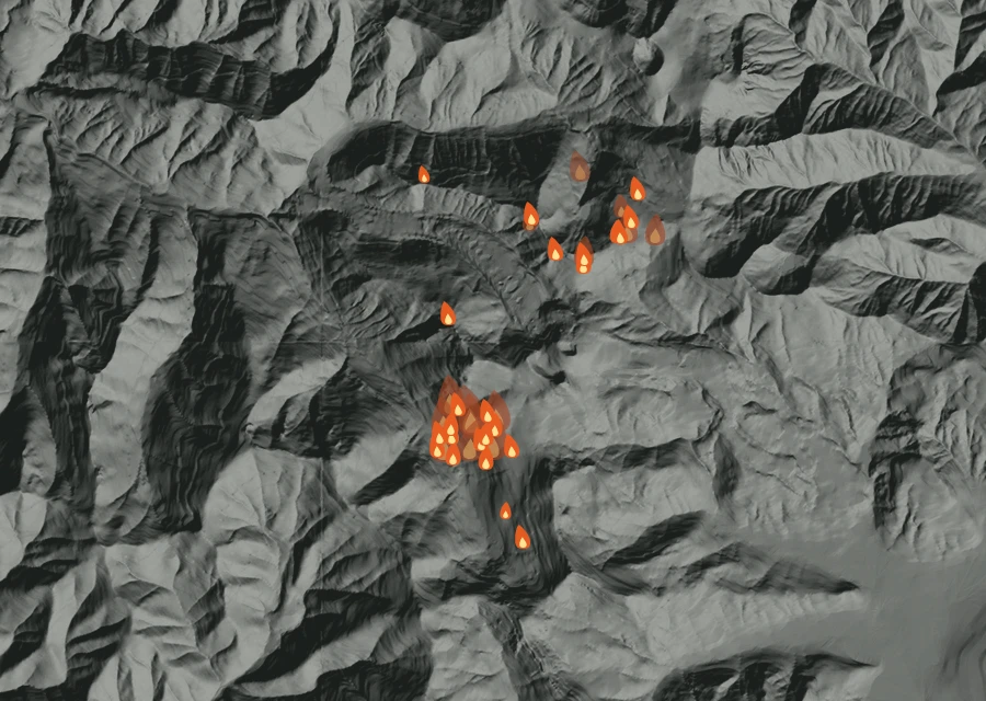 Shaded relief map of the High Lava Fire. Amber flames mark every place that gave off heat in the last day; the shading is the shape of the ground.