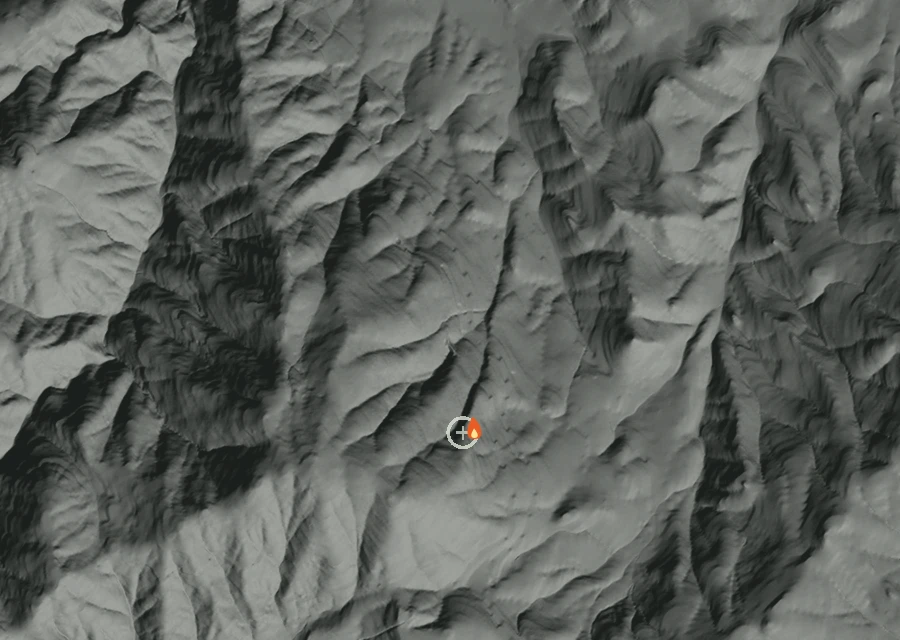 Shaded relief map of the I-5 Mm 9 Sb Fire. Amber flames mark every place that gave off heat in the last day; the shading is the shape of the ground.