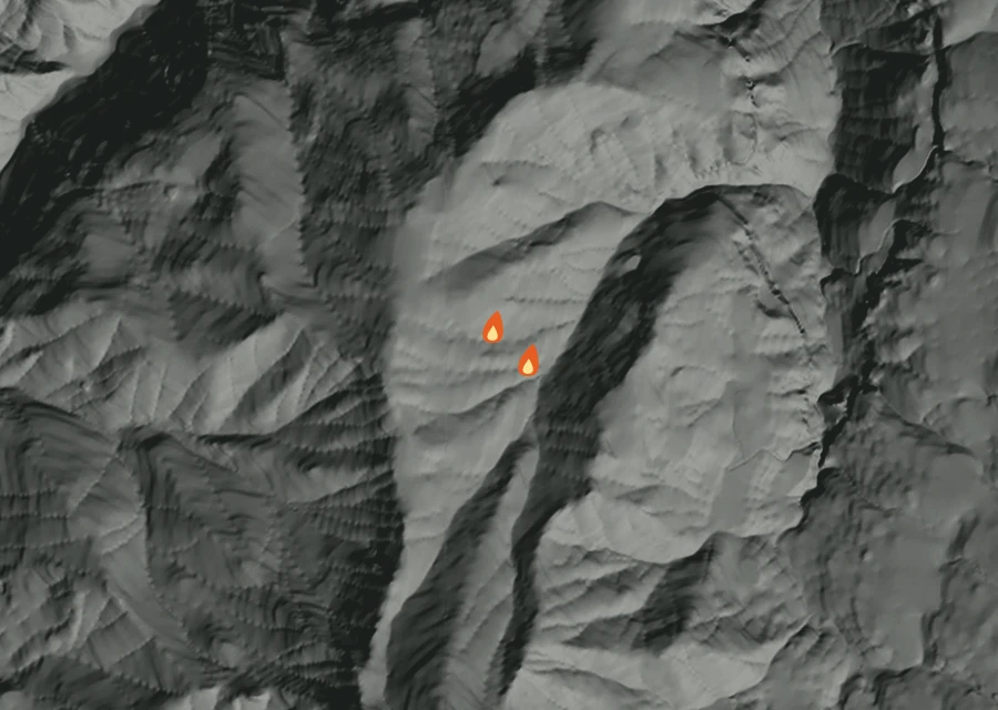 Shaded relief map of the Jack Creek Fire. Amber flames mark every place that gave off heat in the last day; the shading is the shape of the ground.