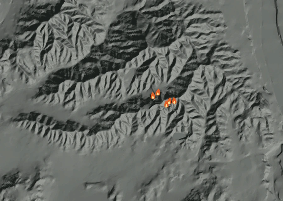 Shaded relief map of the Lac-379048 Fire. Amber flames mark every place that gave off heat in the last day; the shading is the shape of the ground.