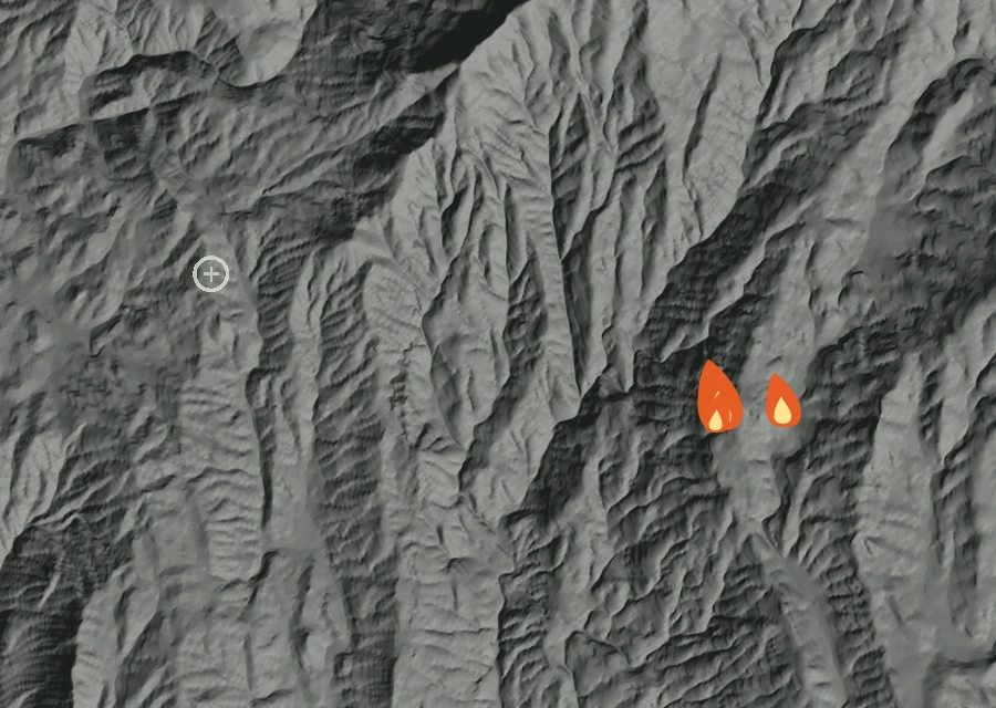 Shaded relief map of the Land Fire. Amber flames mark every place that gave off heat in the last day; the shading is the shape of the ground.