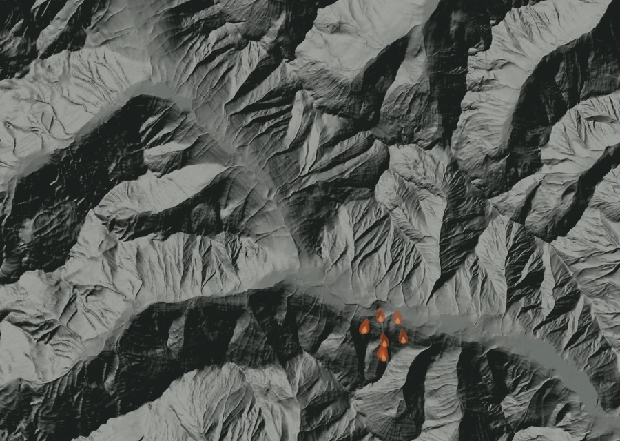 Shaded relief map of the Luna Fire. Amber flames mark every place that gave off heat in the last day; the shading is the shape of the ground.