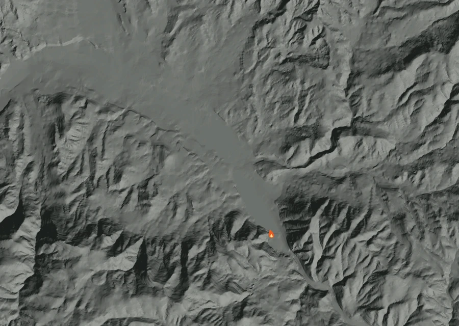 Shaded relief map of the Manning Creek Fire. Amber flames mark every place that gave off heat in the last day; the shading is the shape of the ground.