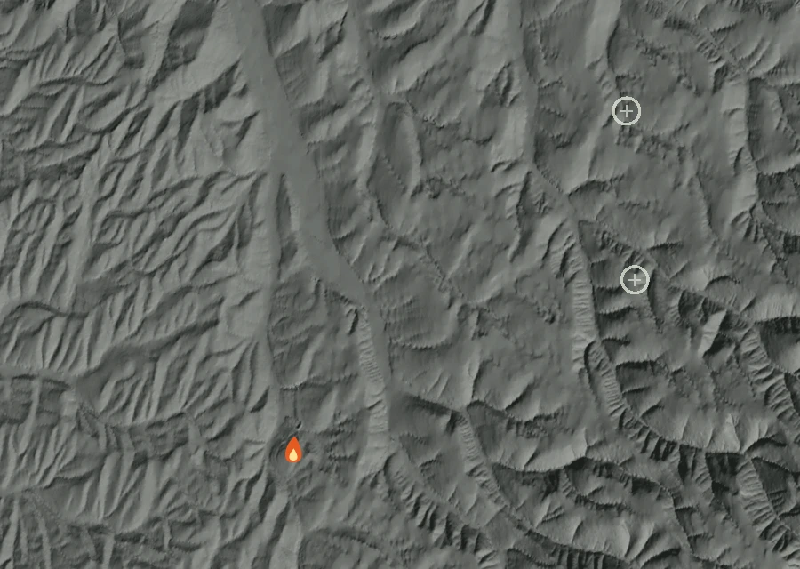 Shaded relief map of the McCowan Road Mutual Aid Fire. Amber flames mark every place that gave off heat in the last day; the shading is the shape of the ground.