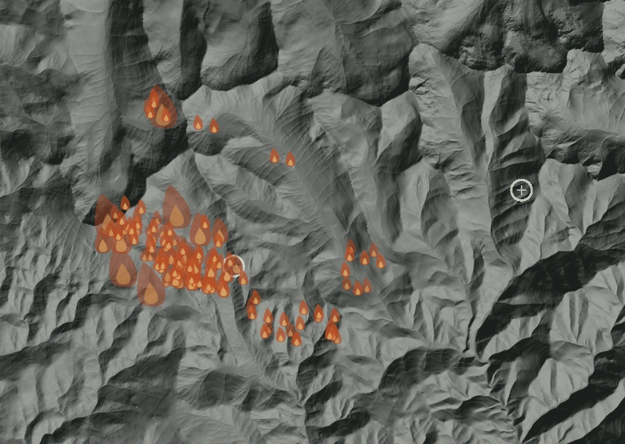 Shaded relief map of the McCully Fire. Amber flames mark every place that gave off heat in the last day; the shading is the shape of the ground.