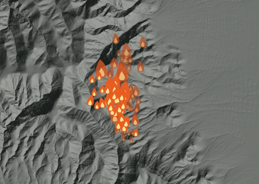 Shaded relief map of the Mitchell Springs Fire. Amber flames mark every place that gave off heat in the last day; the shading is the shape of the ground.
