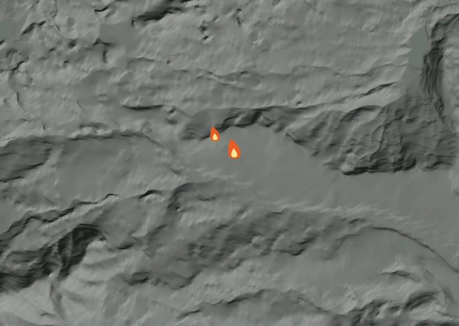 Shaded relief map of the Monk Fire. Amber flames mark every place that gave off heat in the last day; the shading is the shape of the ground.