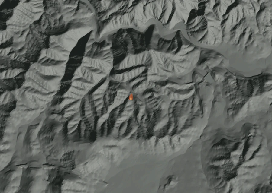 Shaded relief map of the Muse Fire. Amber flames mark every place that gave off heat in the last day; the shading is the shape of the ground.