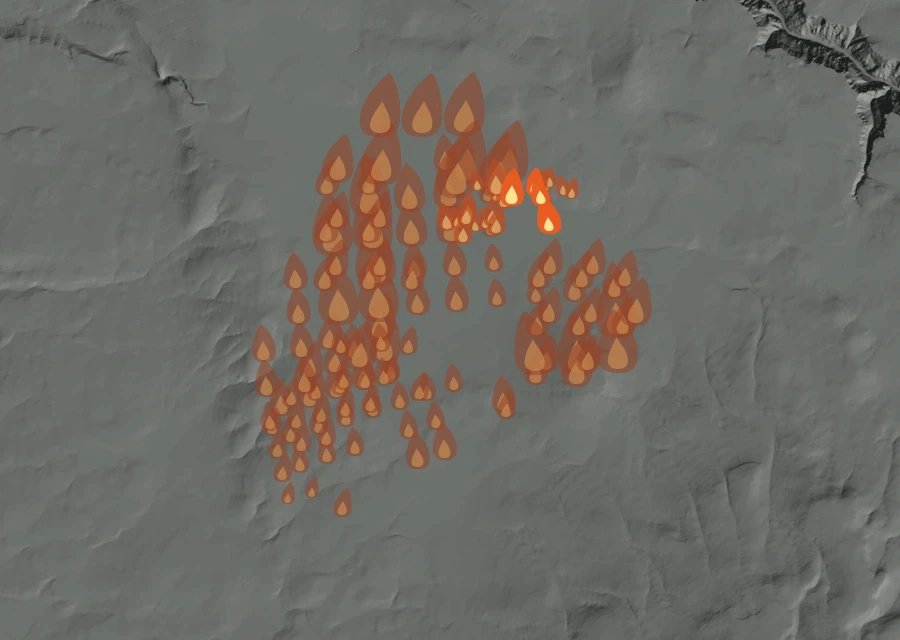 Shaded relief map of the Mustang Fire. Amber flames mark every place that gave off heat in the last day; the shading is the shape of the ground.