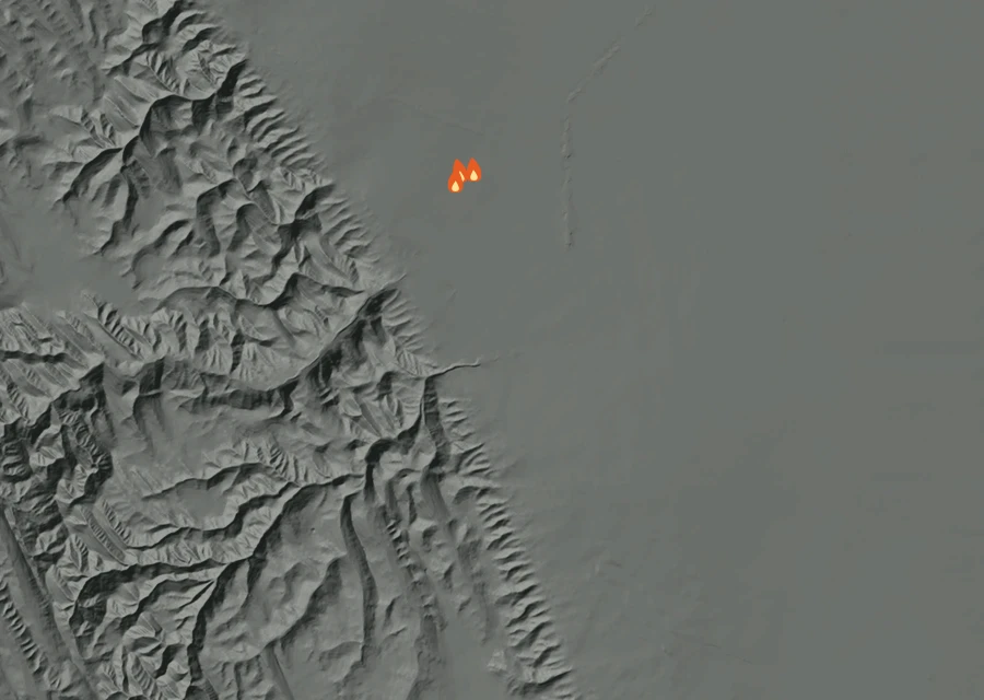 Shaded relief map of the Nees Fire. Amber flames mark every place that gave off heat in the last day; the shading is the shape of the ground.