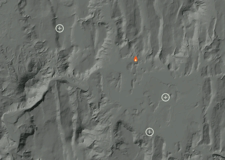 Shaded relief map of the Outpost Fire. Amber flames mark every place that gave off heat in the last day; the shading is the shape of the ground.