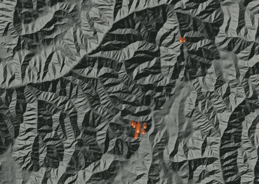 Shaded relief map of the Paradise Fire. Amber flames mark every place that gave off heat in the last day; the shading is the shape of the ground.