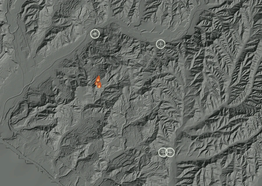 Shaded relief map of the Prima Fire. Amber flames mark every place that gave off heat in the last day; the shading is the shape of the ground.