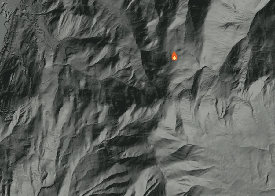 Shaded relief map of the Rickey Canyon Fire. Amber flames mark every place that gave off heat in the last day; the shading is the shape of the ground.