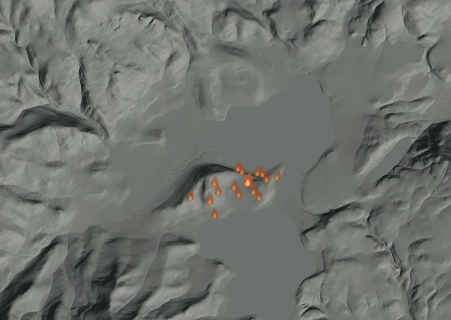 Shaded relief map of the Rocky Point Fire. Amber flames mark every place that gave off heat in the last day; the shading is the shape of the ground.